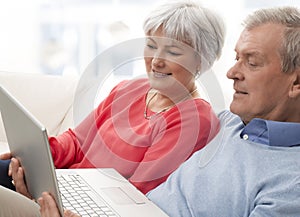 Close-up of a senior couple using laptop