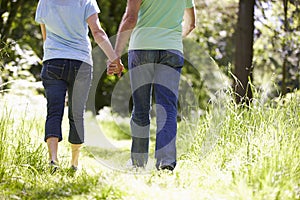 Close Up Of Senior Couple Walking In Summer Countryside
