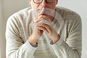 Close up of senior man in glasses thinking