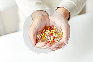 Close up of senior man hands holding pills