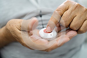 Close-up Of Senior Man Pressing Alarm Button