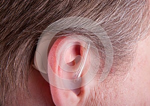 Close-up of a senior man& x27;s ear wearing hearing aid