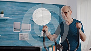 Close up of senior man training with stationary bicycle