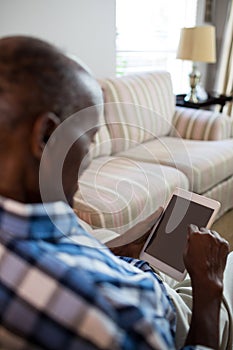 Close up of senior man using tablet