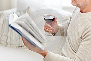 Close up of senior man with wine reading book