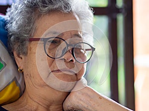 Close-up of a senior woman hand touch on her face. Space for text. Concept of aged people and healthcare