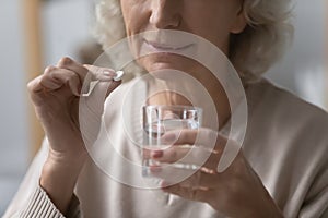 Close up of senior woman having pills feeling unhealthy