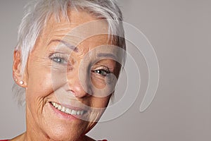 Close-up senior woman with toothy smile