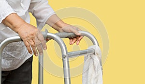 Senior woman using a walker cross street with caregiver