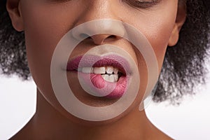 Close up of sensual ethnic female bite her lip