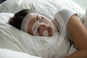 Close up serene calm beautiful woman sleeping on soft pillow