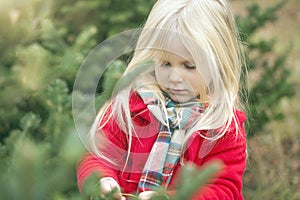 Close-up of serious little girl walking in forest