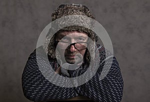 Close up of a serious mature man wearing a winter hat