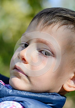 Close Up of Serious Young Boy Outdoors