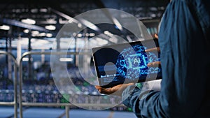 Close up of server farm admin using tablet to do AI automatization