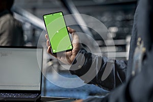 Close up of server farm software developer using mockup phone
