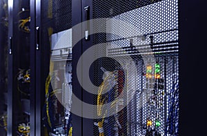 Close up server rack with LED indicator inside under meshed door. Computer server in rack, network and hardware. Inside mainframe