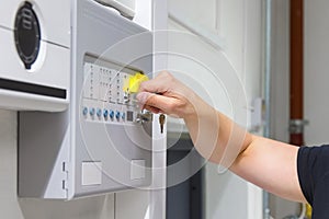 Close-up of Service Technician Opening Fire Panel In Server Room