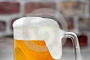 Close up Serving a refreshing beer mug with foam on a white bar