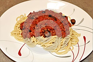 Close-up of Spaghetti and Meat Sauce on Red and White Plate