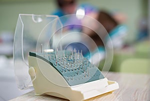 Close-up of set of different dental burs and dental equipment