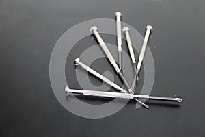 Close up set of small screwdrivers on black background