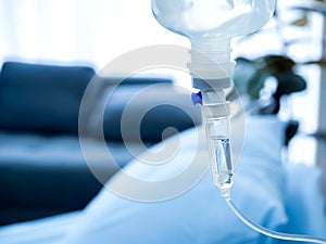 Close up of set vitamin iv fluid intravenous drip saline drop near the patient bed in hospital room.