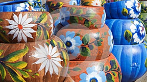 Close up on sets of colorful hand painted Mexican ceramic pots