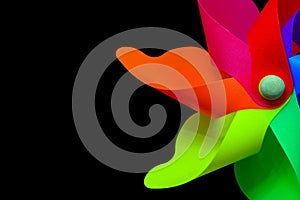 Close up of a seven colors pinwheel on black background