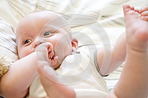 Close up of seven month old baby lying on back