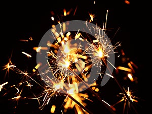 Close up several firework sparklers over black
