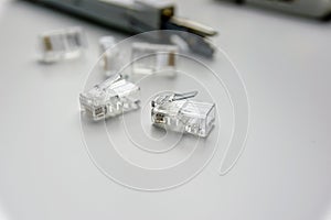 close-up of several rj45 connectors and other tools on a white table
