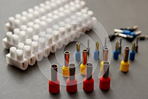 Close up several Wire Ferrule and terminal block w wire on top of a black table