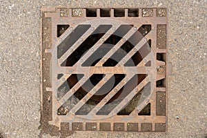 Close-up of sewer grate on asphalt