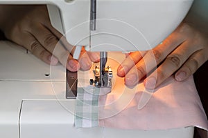 Close up sewing fabric with white sewing machine