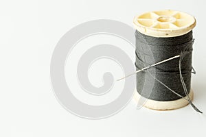 Close up of sewing items,Spool of thread, needle and button