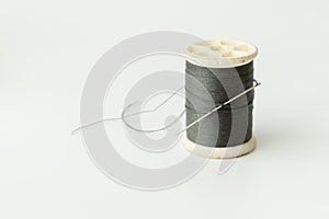 Close up of sewing items,Spool of thread, needle and button