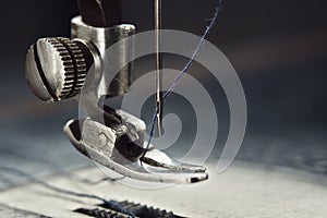 Close up of sewing machine needle with thread. Working part of old sewing machine