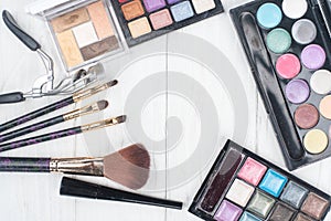 Close up shadow kit with brushes for make-up.beauty background.