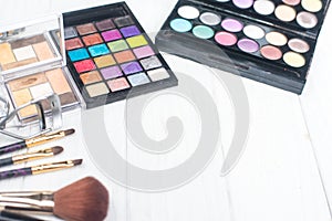 Close up shadow kit with brushes for make-up.beauty background.