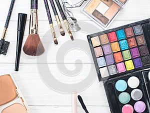 Close up shadow kit with brushes for make-up.beauty background.