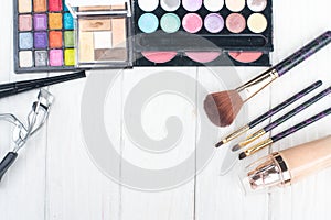 Close up shadow kit with brushes for make-up.beauty background.