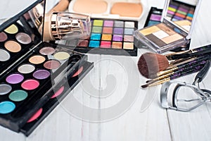 Close up shadow kit with brushes for make-up.beauty background.