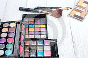 Close up shadow kit with brushes for make-up.beauty background.