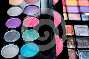 Close up shadow kit with brushes for make-up.beauty background.