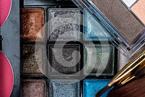 Close up shadow kit with brushes for make-up.beauty background.