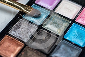 Close up shadow kit with brushes for make-up.beauty background.