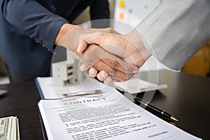 Close up shake hands, Considering buying a home, investing in real estate. Broker signs a sales agreement. agent, lease agreement