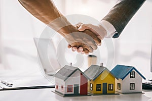 Close up shake hands, Considering buying a home, investing in real estate. Broker signs a sales agreement. agent, lease agreement