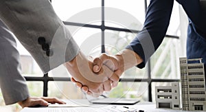 Close up shake hands, Considering buying a home, investing in real estate. Broker signs a sales agreement. agent, lease agreement